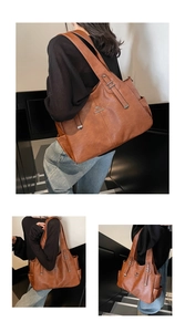 Close-up of caramel brown tote bag featuring kangaroo logo and premium leather texture