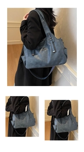 Close-up of grey-blue leather tote bag with side pockets and metal kangaroo logo detail