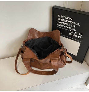 Interior view of brown PU leather tote bag showing spacious lining and internal pockets