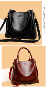Close-up of luxury leather texture and gold kangaroo logo on two large tote bags