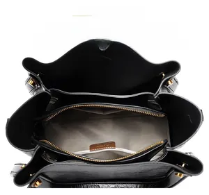 Top view of large black tote bag interior showing multiple organized compartments and zip pocket