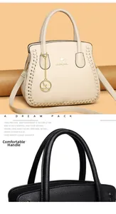 Detail of comfortable carry handles and premium litchi grain leather on tote bag