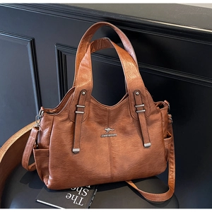Detail of brown litchi pattern leather bag with kangaroo logo and side pocket