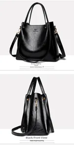 Macro detail of black leather tote bag with embossed kangaroo logo and gold hardware