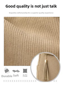 Detail of khaki corduroy bag fabric with soft texture, wear-resistant finish and tassel