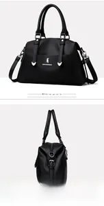 Détails du sac cabas en cuir noir à motif litchi avec logo argenté et poignée solide