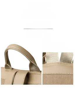 Detail of khaki synthetic leather backpack showing reinforced handle and precise stitching