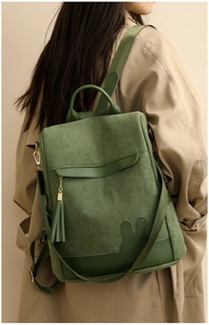 Detail of forest green corduroy backpack with cute rabbit ears and tassel on a model