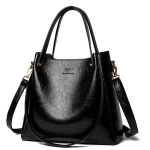 Elegant black oil-wax leather tote bag with kangaroo logo and gold hardware details