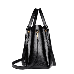 Elegant black oil wax leather bucket tote bag with vintage texture and golden hardware