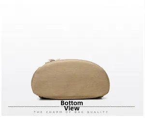 Detailed bottom view of the khaki corduroy backpack showing oval base and textured fabric