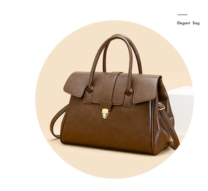 Detail of vintage brown tote bag showing smooth PU leather texture and golden metal shield lock