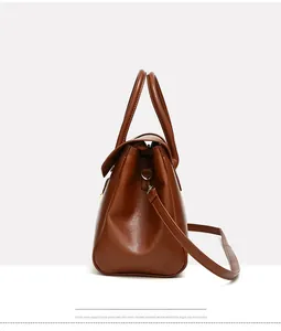 Detailed side view of dark brown vintage leather tote bag with sturdy handles
