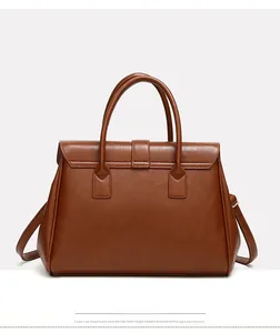 Detail view of the brown leather tote bag showing fine stitching and smooth back texture