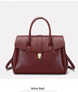 Detail of wine red leather tote handbag showing gold metal buckle and texture