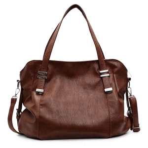 Brown vintage faux leather tote bag with silver hardware and adjustable strap