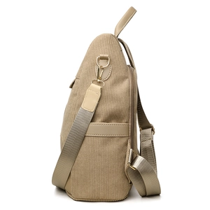 Side view of beige corduroy anti-theft backpack with side pocket and gold hardware