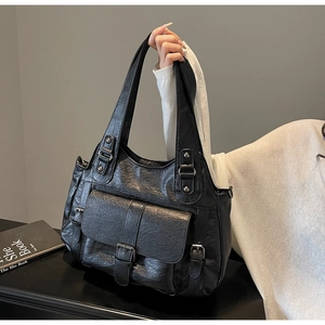 Close-up of retro large tote bag featuring vintage texture and metal buckle detail
