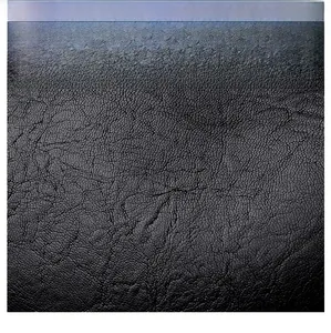 Macro shot of premium black oil wax leather fabric with natural textured grain