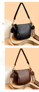 Close-up of texture PU leather bucket bag with wide geometric strap and golden hardware