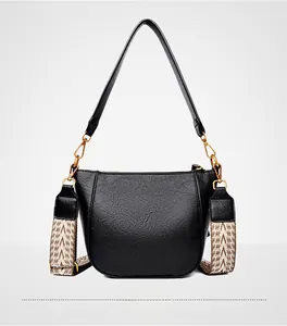 Back view of a black pebbled leather bucket bag with golden hardware and two straps