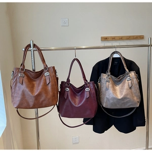 Detailed comparison of three large tote bags in dark brown, burgundy and bronze colors