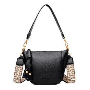 Black pebbled leather half-moon bucket bag with woven wide strap and golden hardware