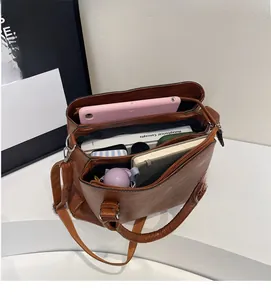 Macro view of spacious interior compartments in vintage brown leather tote bag