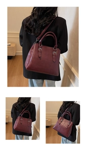 Detail of burgundy leather handbag showing sturdy handles and textured finish for office wear