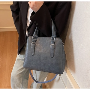 Detail shot of the blue retro lychee grain leather tote bag with silver buckle accents