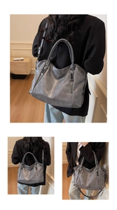 Detail of grey retro leather tote bag with durable handles and adjustable strap