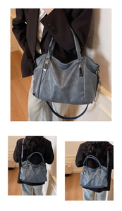 Detail of grey-blue tote bag showing soft retro faux leather texture and silver hardware