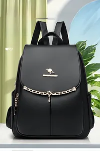 Detail of black pebbled leather backpack with gold chain and kangaroo logo accent