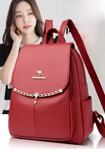 Detail of burgundy lychee leather backpack with golden kangaroo logo and chain