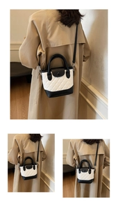 Dettaglio di una mini borsa a secchiello trapuntata bianca e nera su un trench coat