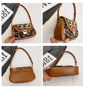 Detail view of leopard print shoulder bag with silver round buckle and leather texture