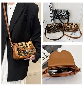 Detail of leopard print crossbody bag showing metal rotary lock and interior storage space