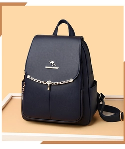 Detail of navy blue leather backpack featuring golden kangaroo logo and chain tassel accent
