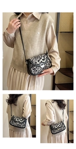 Detailed view of leopard print shoulder bag with silver round buckle and black straps