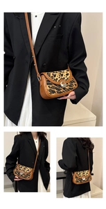 Detailed close-up of leopard print crossbody saddle bag with vintage silver metal buckle