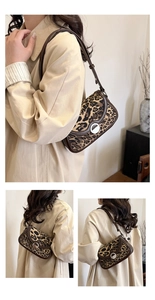 Detail of leopard print shoulder bag with brown leather trim and silver metal buckle closure