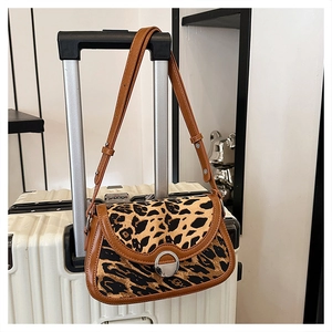 Detailed leopard print shoulder bag with brown leather trim and metal buckle closure