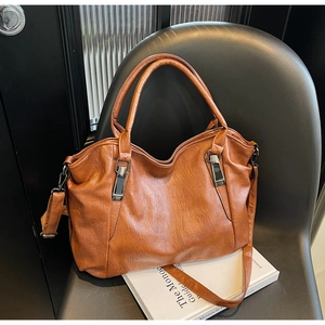 Detailed view of caramel brown tote bag with smooth texture and adjustable shoulder strap
