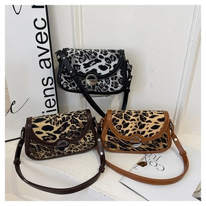 Detailed view of three leopard print crossbody bags with elegant silver metal ring buckles