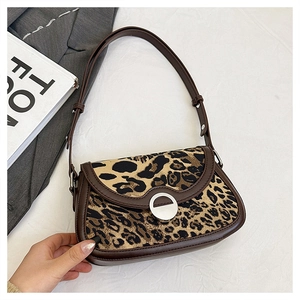 Close-up of leopard print shoulder bag with silver ring buckle and leather trim detail