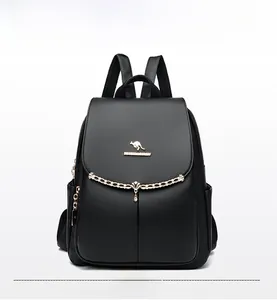 Close-up of black lychee leather backpack with golden kangaroo logo and chain detail