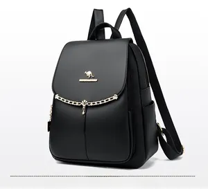 Close-up of black lychee grain leather backpack with golden kangaroo logo and metal chain detail