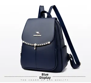 Detail view of blue textured leather backpack with golden kangaroo logo and chain