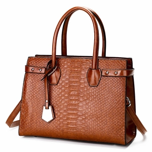 Brown crocodile-textured tote bag with top handles and adjustable shoulder strap