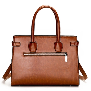 Brown oil-wax leather tote bag with silver zipper and adjustable shoulder strap for women